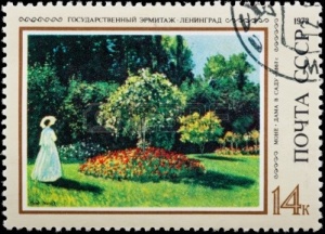 10016316-znaczek-pocztowy-kobieta-w-biaa--ego-ubrania-z-parasol-w-ogrodzie